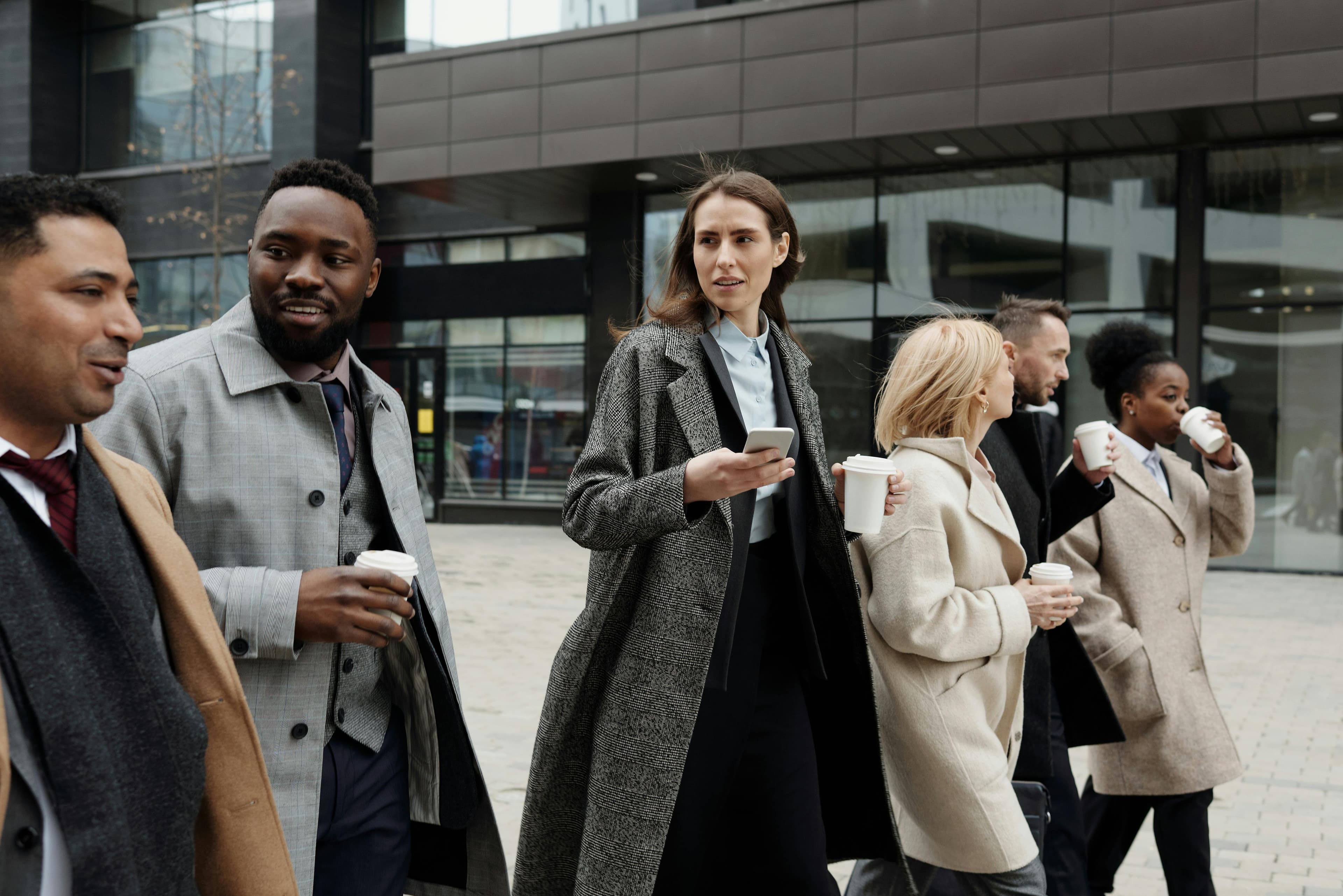 Business people walking in front of an office building